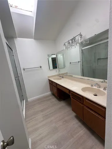 a spacious bathroom with a granite countertop sink and a mirror