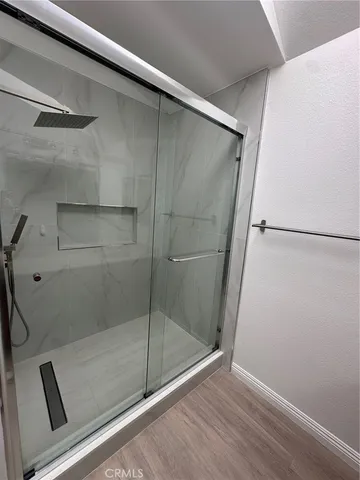 a bathroom with a glass shower door