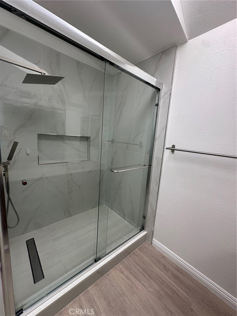 13470 Mallorca Lane Chino Hills, CA 91709 - Photo 32 of 44 a bathroom with a glass shower door