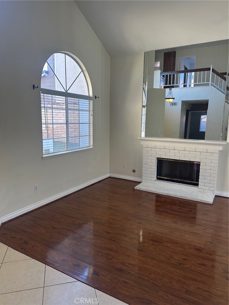 13470 Mallorca Lane Chino Hills, CA 91709 - Photo 5 of 44 an empty room with wooden floor fireplace and windows