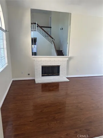 a view of a hallway with wooden floor and entryway