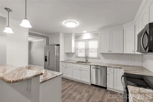 a kitchen with a sink and a refrigerator