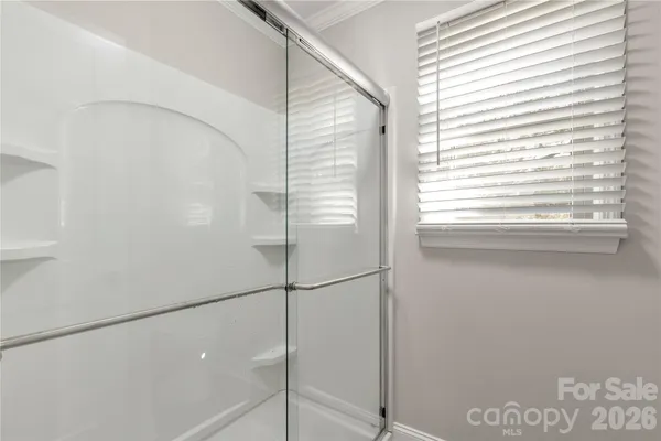 a bathroom with a glass shower door