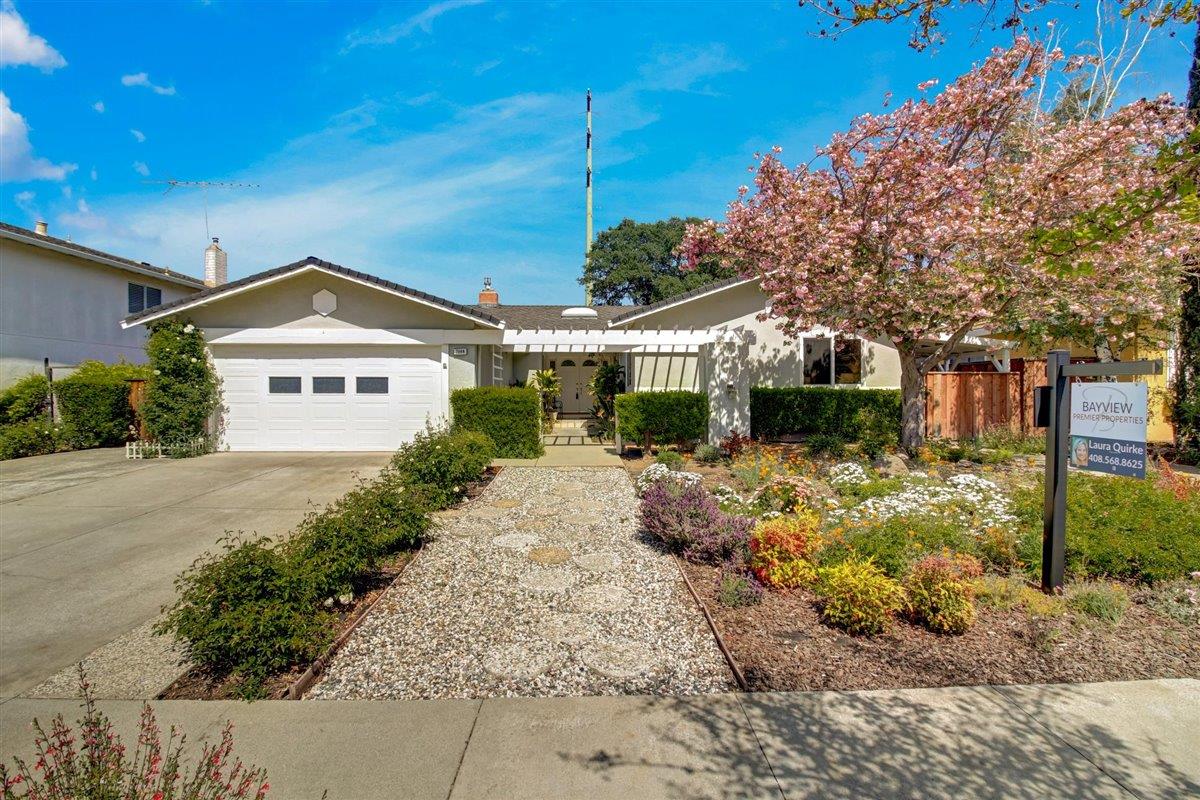 a front view of a house with garden