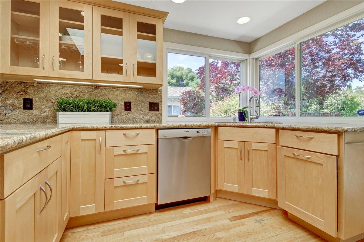 7068 Brooktree Way San Jose, CA 95120 - Photo 12 of 40 a kitchen with granite countertop cabinets stainless steel appliances a sink and a large window