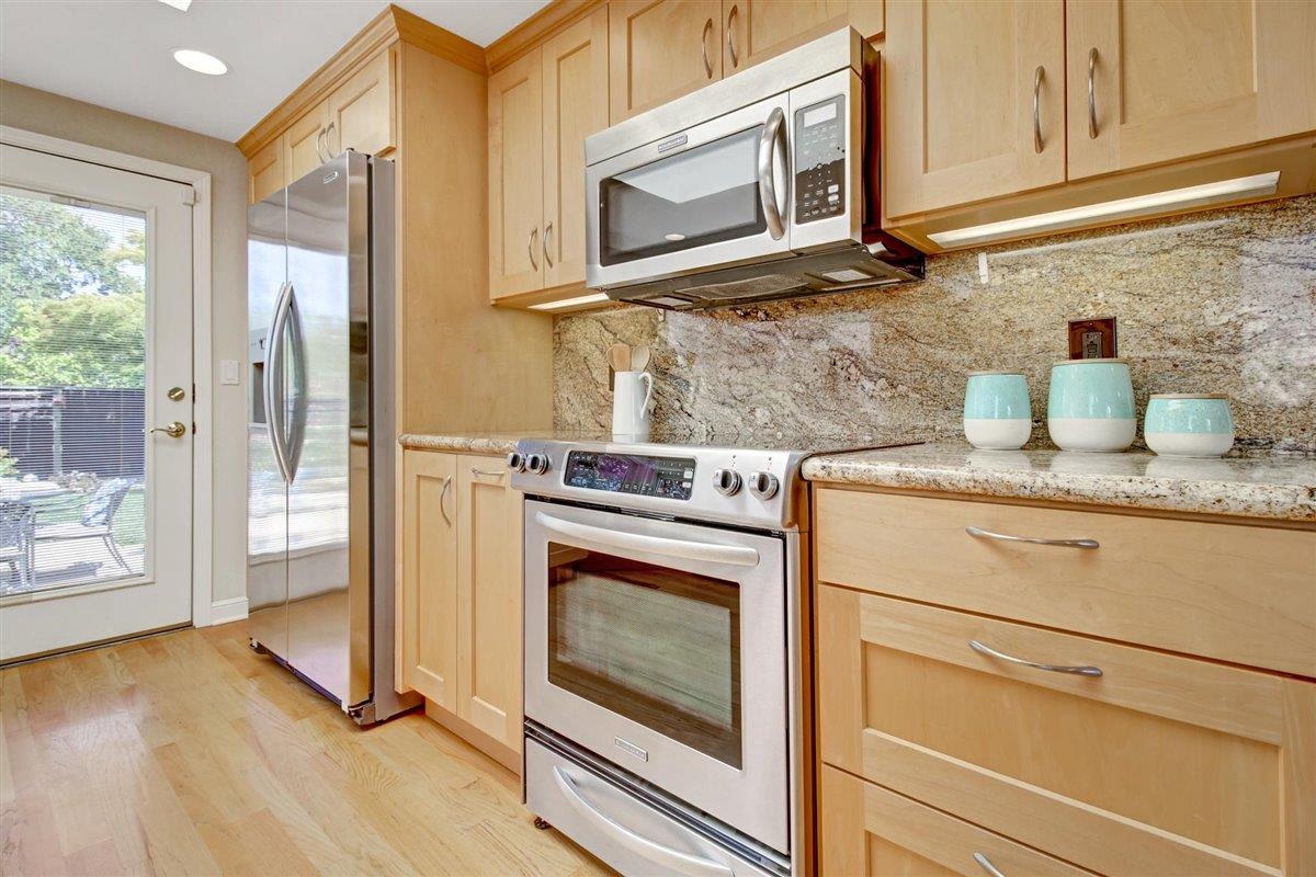 7068 Brooktree Way San Jose, CA 95120 - Photo 13 of 40 a kitchen with granite countertop cabinets stainless steel appliances and a wooden floor