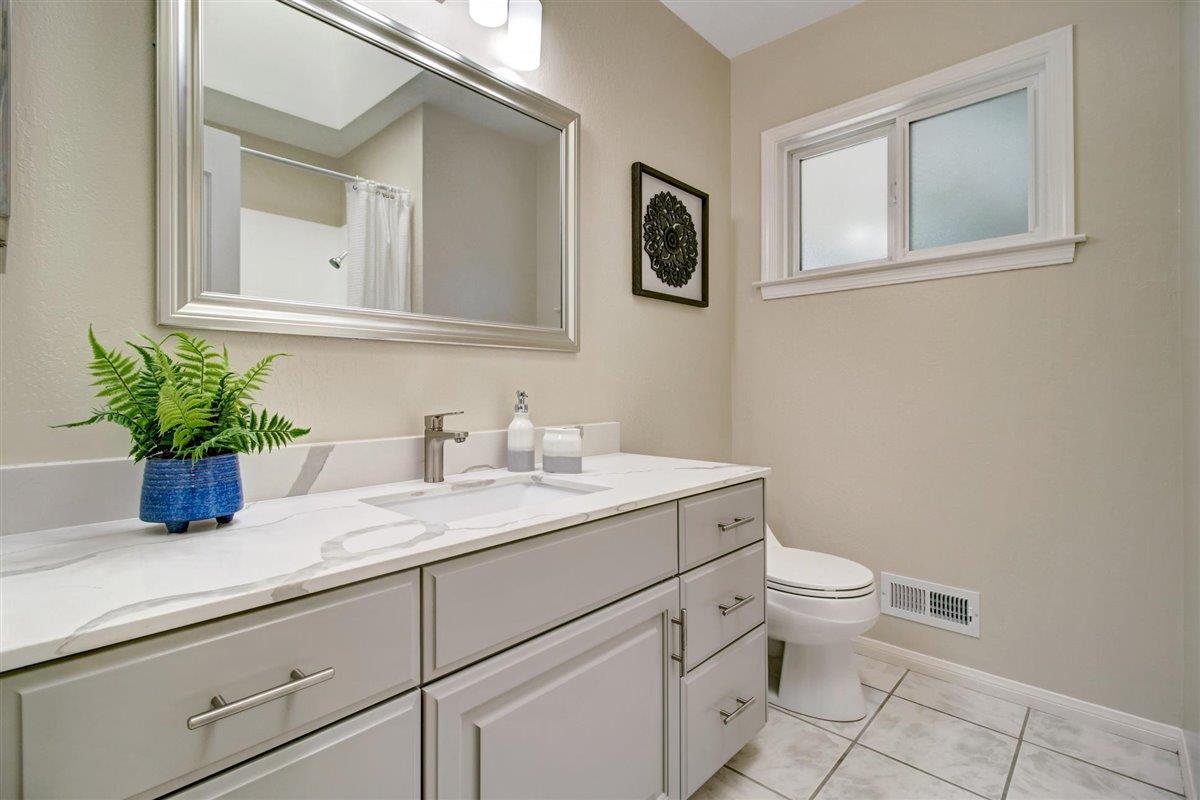 7068 Brooktree Way San Jose, CA 95120 - Photo 38 of 40 a bathroom with a granite countertop toilet sink and mirror