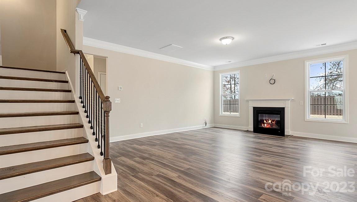149 Fox Cove Road Hendersonville, NC 28792 - Photo 17 of 34 a view of an empty room with wooden floor fireplace and windows