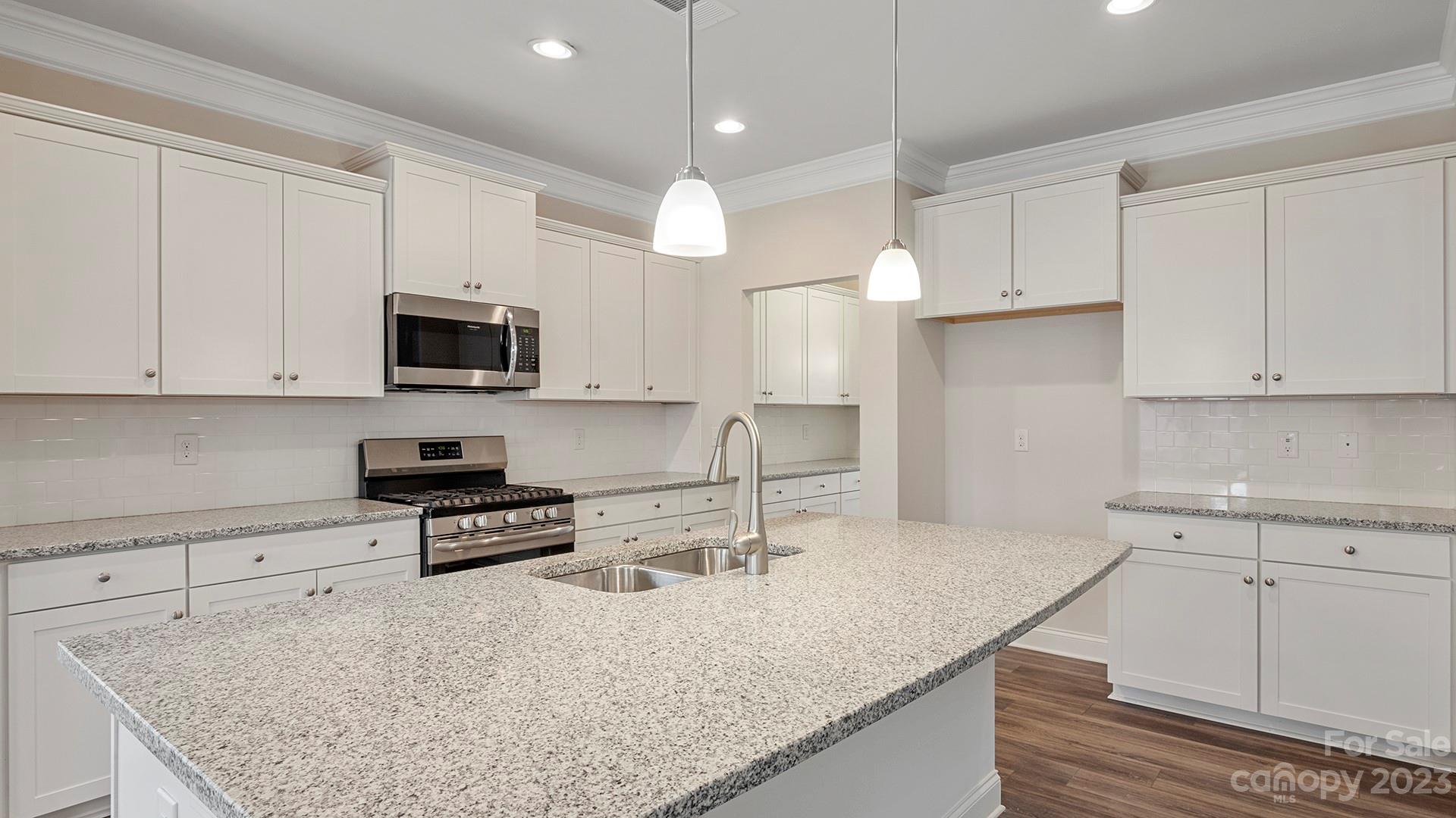 149 Fox Cove Road Hendersonville, NC 28792 - Photo 8 of 34 a kitchen with stainless steel appliances granite countertop a sink a stove and a granite counter tops