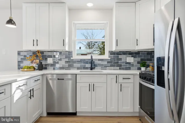 a bedroom with a large bed and a potted plant