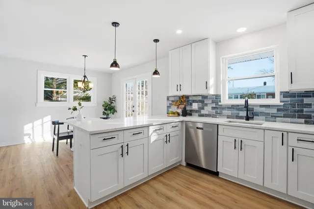 a kitchen with white cabinets and white appliances