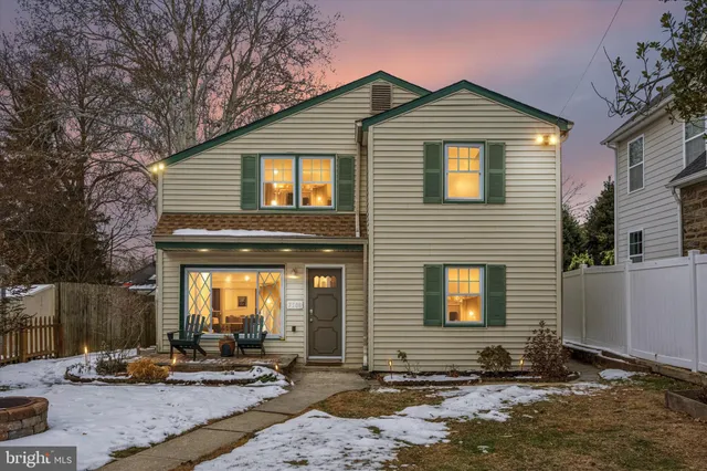 a front view of a house with sitting area