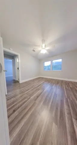 a view of an empty room and wooden floor