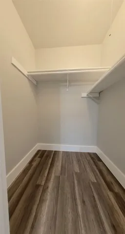 a view of a room with wooden floor