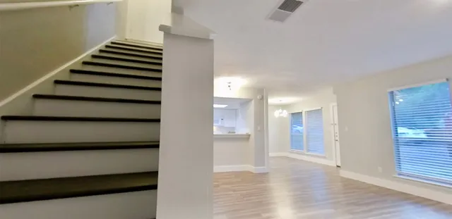 a view of an entryway with wooden floor and stairs