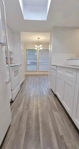 a view of a hallway with wooden shelves