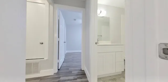 a kitchen with a refrigerator and a stove top oven