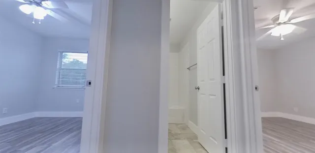 a view of a hallway with wooden floor