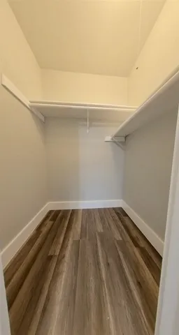 a view of a room with wooden floor