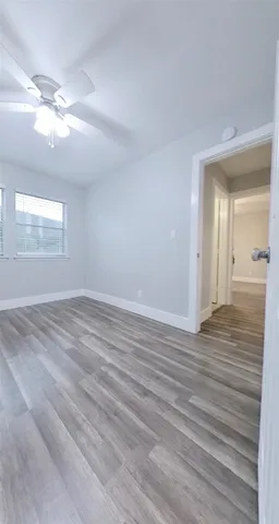 wooden floor in an empty room with a mirror