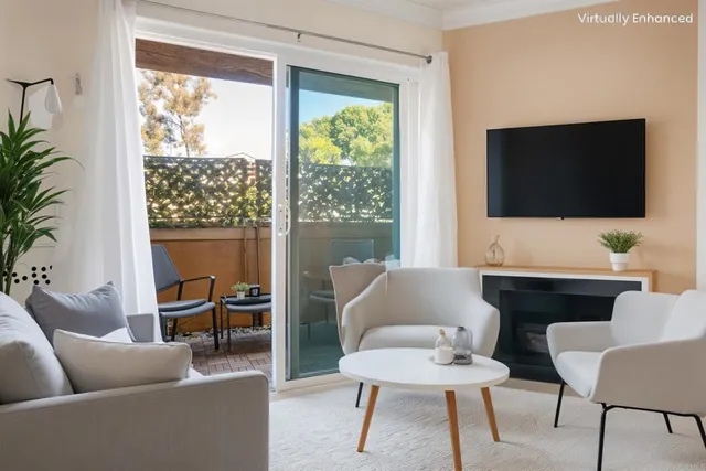 a living room with furniture a flat screen tv and a large window