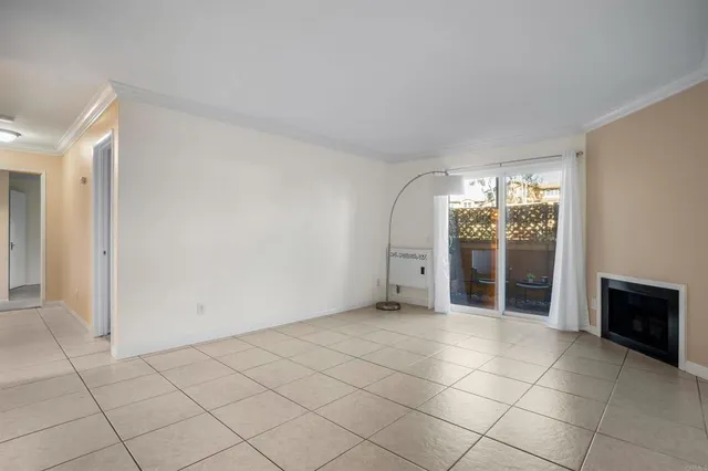 an empty room with fireplace and windows