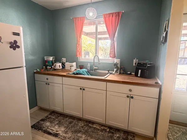 a kitchen with a sink cabinets and window