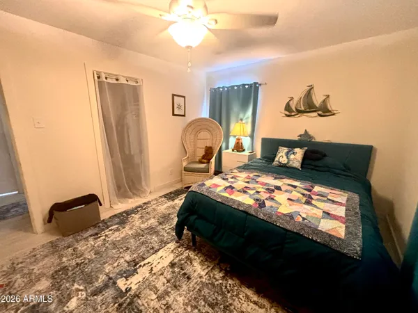 a bedroom with a bed dresser and a window