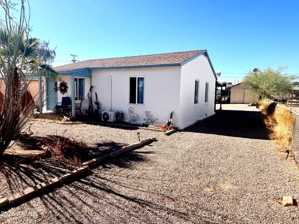 a view of a house with backyard and sitting area