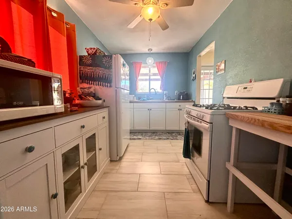 a kitchen with a stove sink and microwave