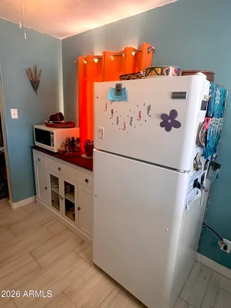 a white refrigerator freezer sitting inside of a kitchen
