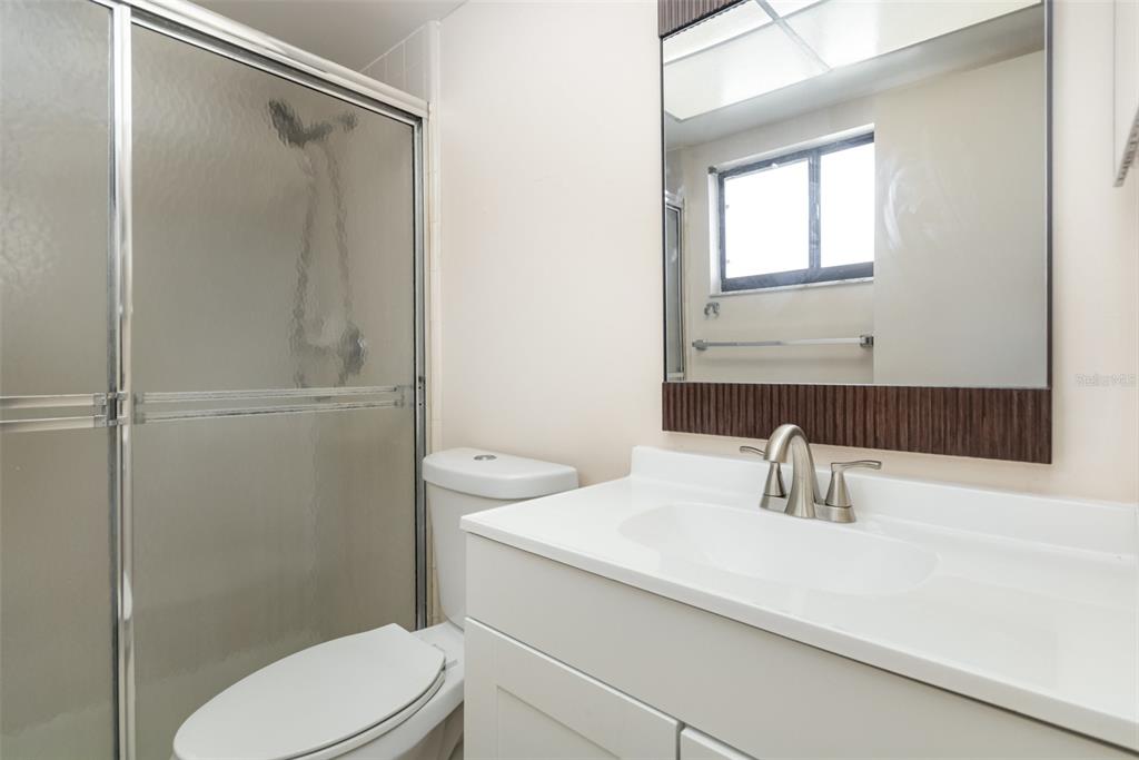 11714 Stamfield Drive Orlando, FL 32821 - Photo 11 of 15 a bathroom with a sink a toilet and shower