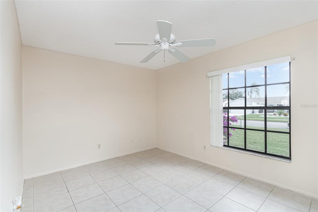 11714 Stamfield Drive Orlando, FL 32821 - Photo 13 of 15 an empty room with windows and fan
