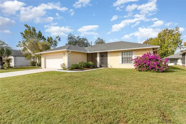 a view of a house with backyard and garden