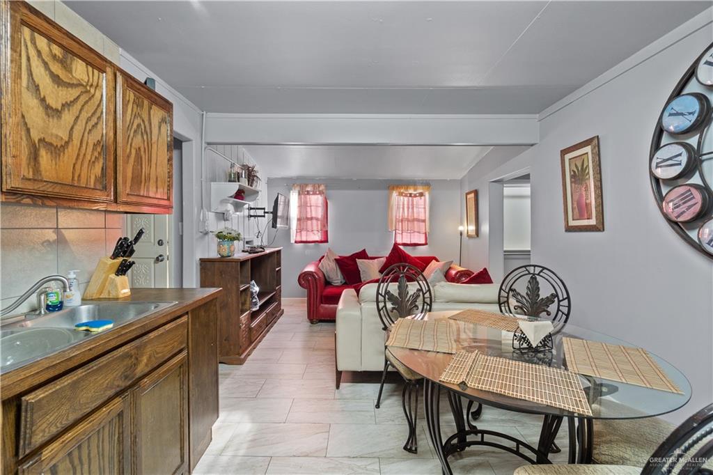 313 North 40th Street McAllen, TX 78501 - Photo 12 of 27 a view of a dining room with furniture and a window
