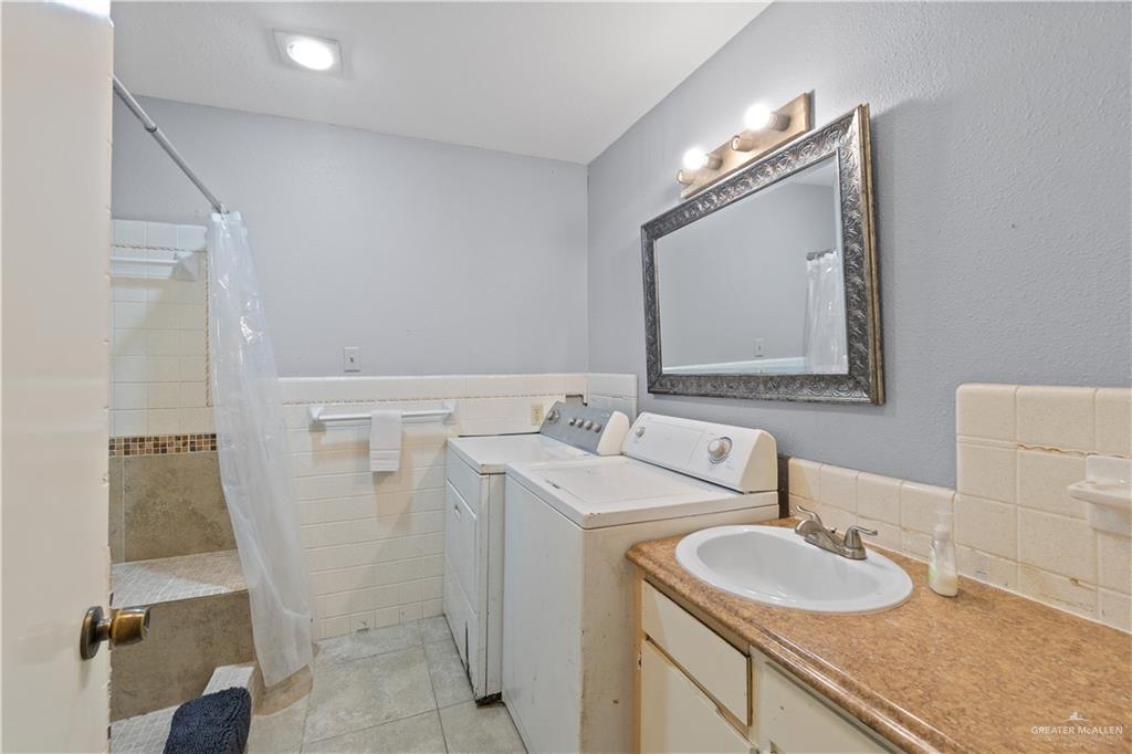 313 North 40th Street McAllen, TX 78501 - Photo 17 of 27 a bathroom with a double vanity sink and mirror