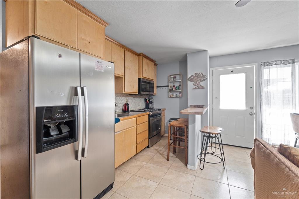 313 North 40th Street McAllen, TX 78501 - Photo 21 of 27 a kitchen with cabinets and chairs