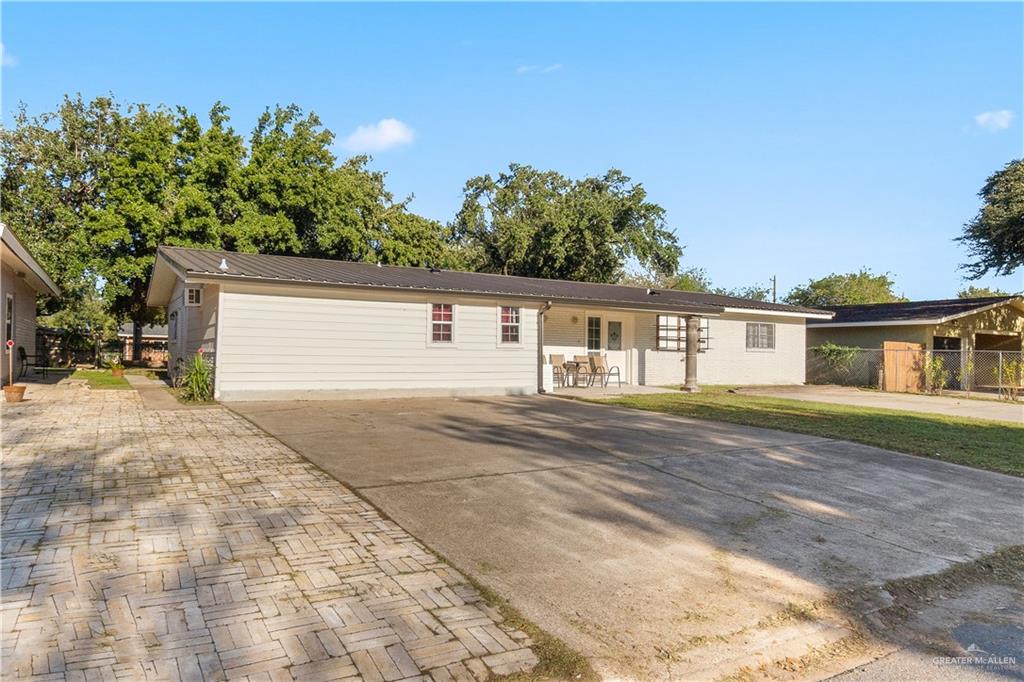 313 North 40th Street McAllen, TX 78501 - Photo 3 of 27 a front view of a house with a yard and trees
