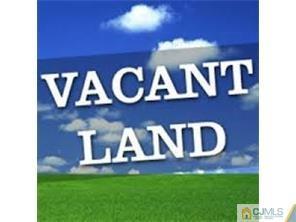 a wall with a bench and a yard