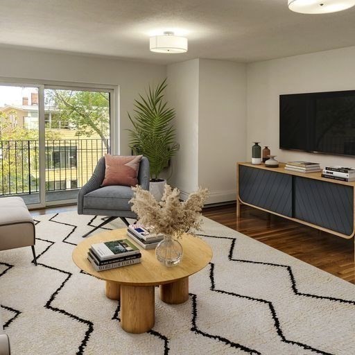 880 East 4th Street, Unit 410 Boston, MA 02127 - Photo 3 of 9 a living room with furniture and a flat screen tv