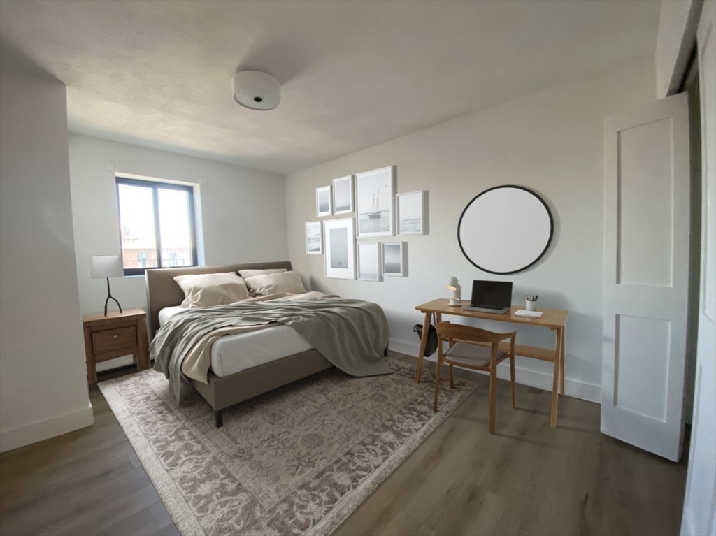 880 East 4th Street, Unit 410 Boston, MA 02127 - Photo 5 of 9 a spacious bedroom with a bed and window