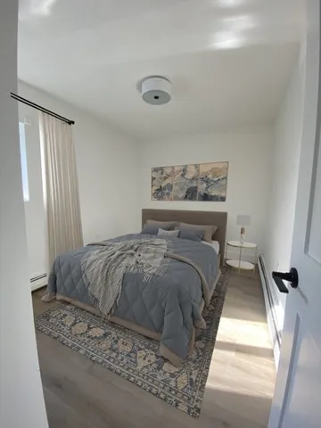 a bedroom with a large bed and a window