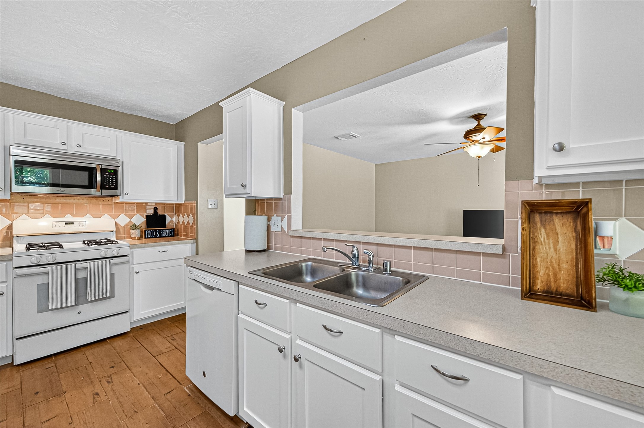 4630 Twisting Road Houston, TX 77084 - Photo 24 of 49 a kitchen with granite countertop white cabinets and white appliances