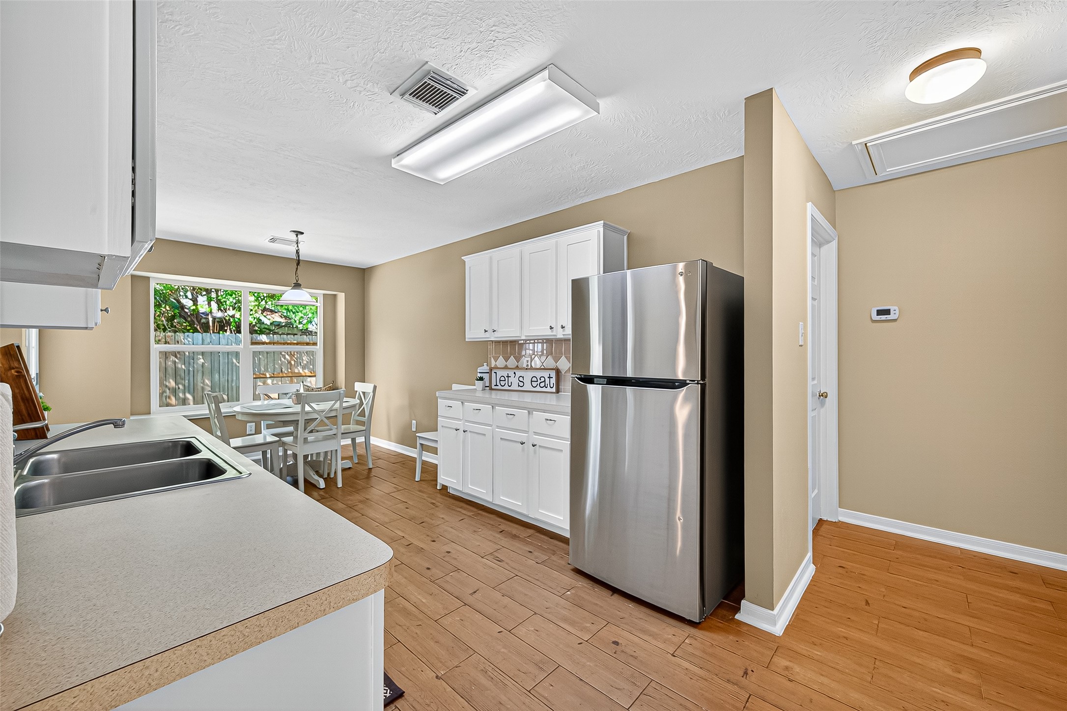 4630 Twisting Road Houston, TX 77084 - Photo 29 of 49 a kitchen with refrigerator a stove a sink and a window