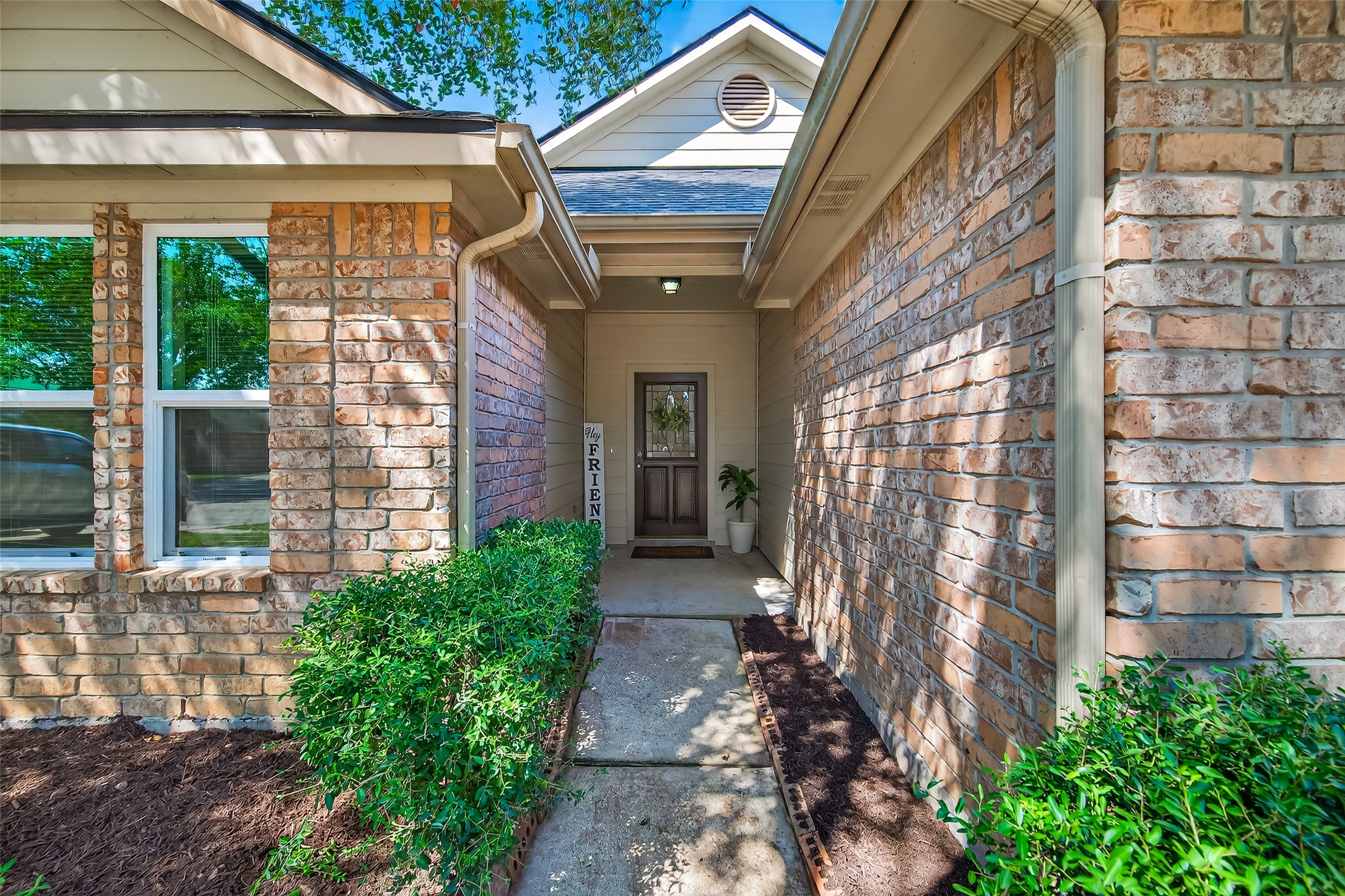 4630 Twisting Road Houston, TX 77084 - Photo 4 of 49 a view of a brick house with a large windows and flower plants