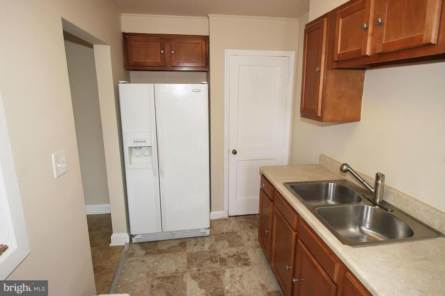 316 Stemmers Run Road Baltimore, MD 21221 - Photo 4 of 20 a kitchen with a sink and refrigerator