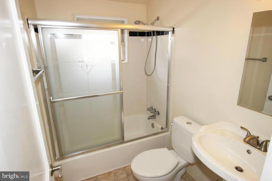 316 Stemmers Run Road Baltimore, MD 21221 - Photo 8 of 20 a bathroom with a sink toilet and shower