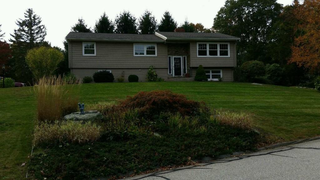 a view of a yard in front of a house with green space