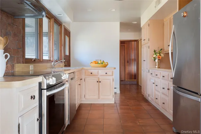 a kitchen with granite countertop a refrigerator and a stove