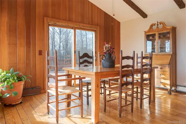a dining room with furniture and wooden floor